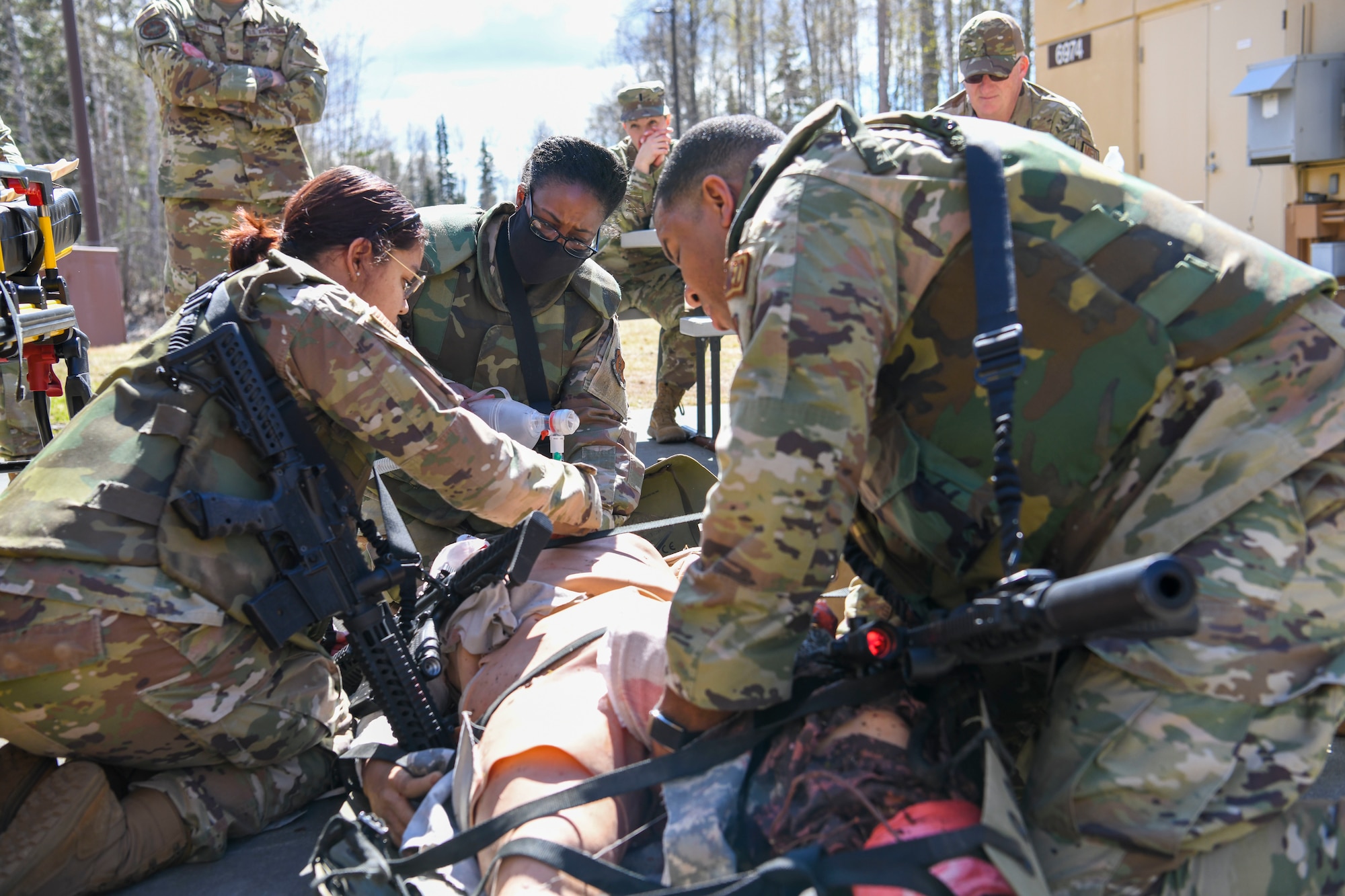 N.Y. Air National Guard airmen from the 106th Rescue Wing, Westhampton Beach, N.Y., treat a “patient,” an advanced medical simulation dummy, at Joint Base Elmendorf-Richardson in Anchorage, Alaska, May 5, 2022. The combat medics of the 106th Medical Group participated in their first Military Facility Annual Training since the start of the COVID-19 pandemic, and were expected to encounter a patient, assess the injuries, mitigate the risk, stop bleeding, treat secondary wounds, and/or resuscitate the patient and maintain the airway. (Air National Guard photo by SSgt Daniel H. Farrell)