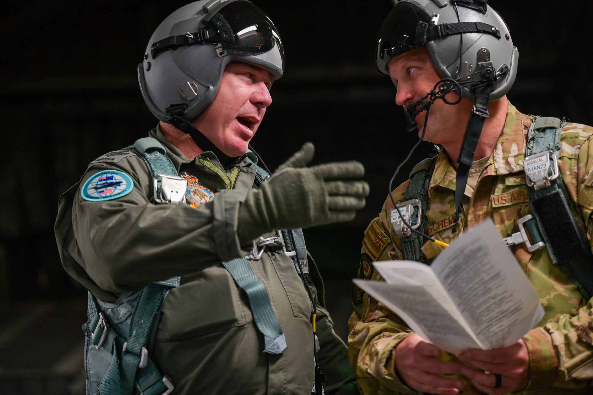 Royal Australian Air Force Flight Sgt. Ben Russell, No. 36 Squadron loadmaster, speaks with U.S. Air Force Tech Sgt. Eric Wiershcem, 204th Airlift Squadron loadmaster, during a training exercise Global Dexterity 2022 at Joint Base Pearl Harbor-Hickam, Hawaii, May 3, 2022. Exercise Global Dexterity 2022 included side-by-side training of C-17s from the USAF, Hawaii Air National Guard, and the RAAF to better develop tactics between the three forces. (U.S. Air Force photo by Staff Sgt. Alan Ricker)