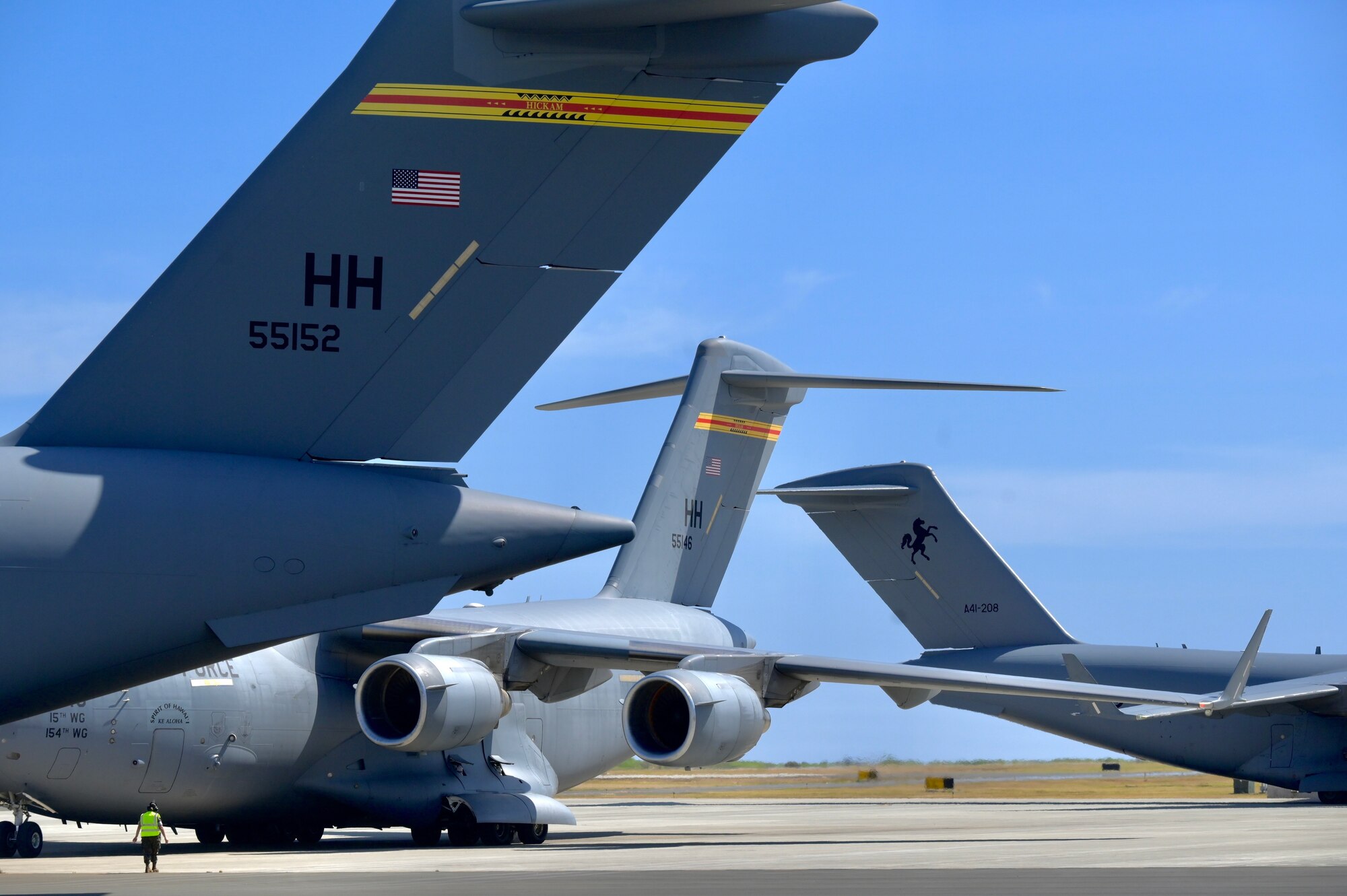 Three C-17 Globemaster III from the 15th Wing, Hawaii Air National Guard, and Royal Australian Air Force sit on the flightline during Exercise Global Dexterity 2022 at Marine Corps Base Hawaii, Hawaii, May 11, 2022. The USAF and RAAF conducted bilateral training in C-17 focused training to enhance their capabilities with the aircraft. (U.S. Air Force photo by 1st Lt. Benjamin Aronson)