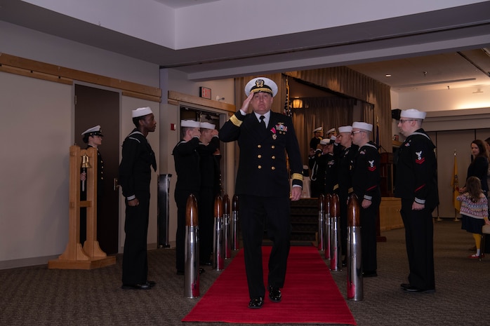 Rear Adm. Brad Collins, outgoing commander, Navy Region Northwest, renders a hand salute while departing a change of command ceremony at Naval Base Kitsap-Bangor, Washington May 12, 2002.  During the ceremony, Rear Adm. Mark Sucato relieved Collins as commander, Navy Region Northwest. (U.S. Navy photo by Mass Communication Specialist 2nd Class Ian Zagrocki)