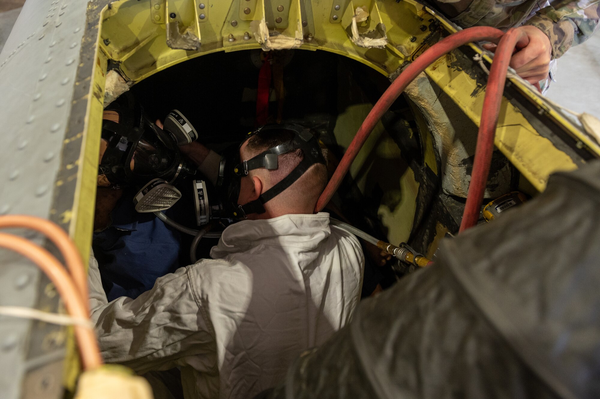 Senior Airman Robert Hiler, 51st Maintenance Squadron aircraft fuels systems technician, assists a simulated unconscious Airman dummy inside a fuel tank compartment of an A-10c Thunderbolt during an annual confined space training and safety event