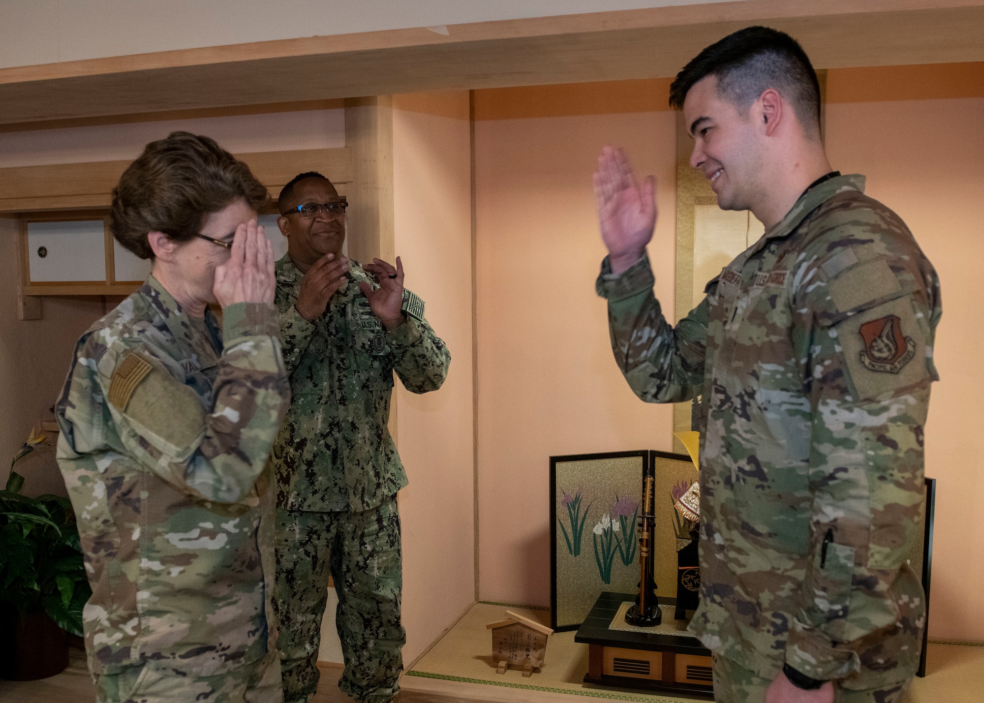 A female general salutes a lieutenant