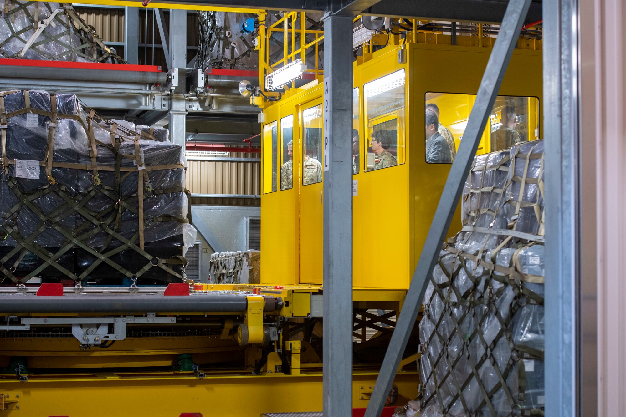 A female general rides in a giant cargo lift