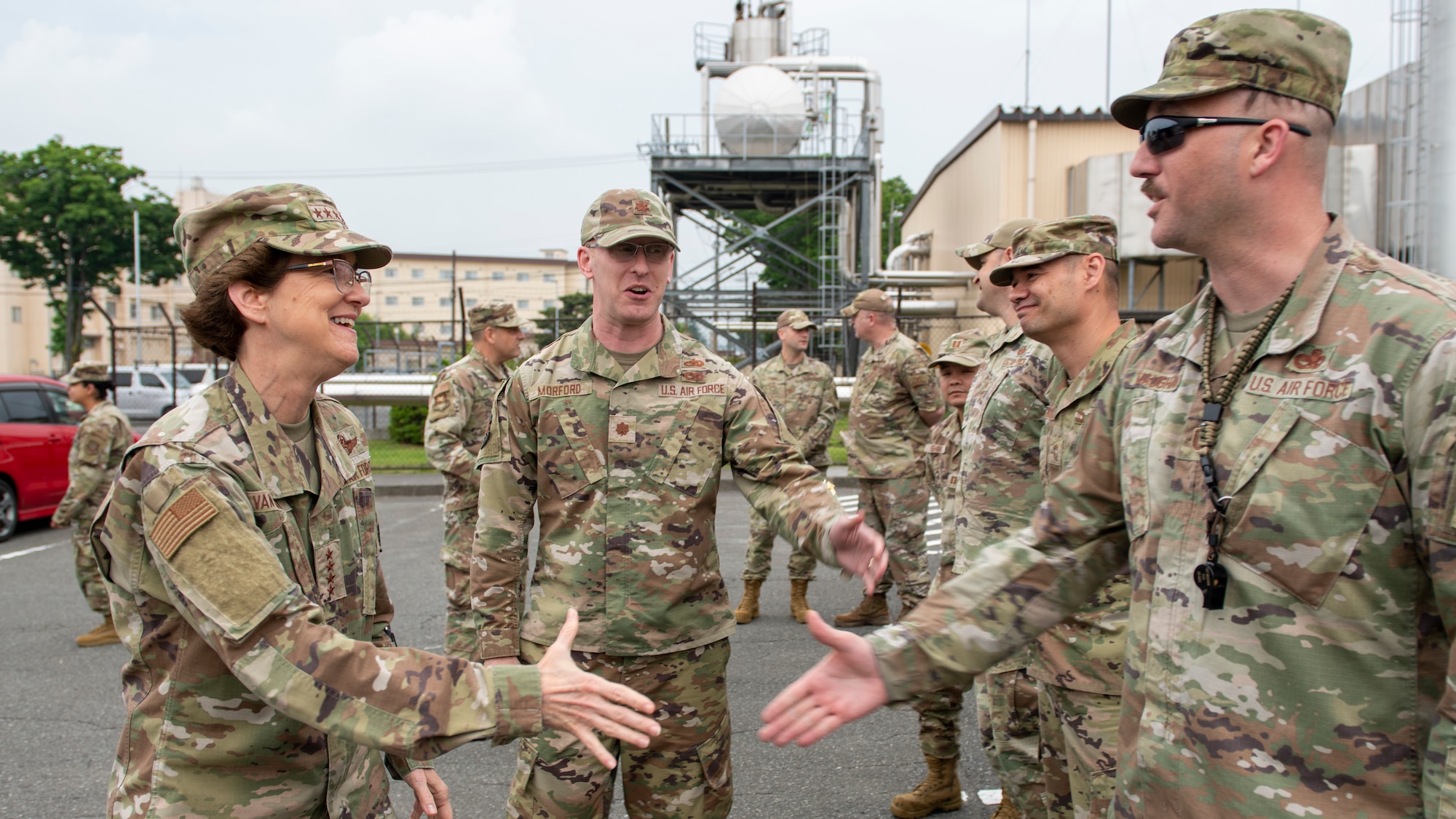 A female general shakes hands with a mustached sergeant