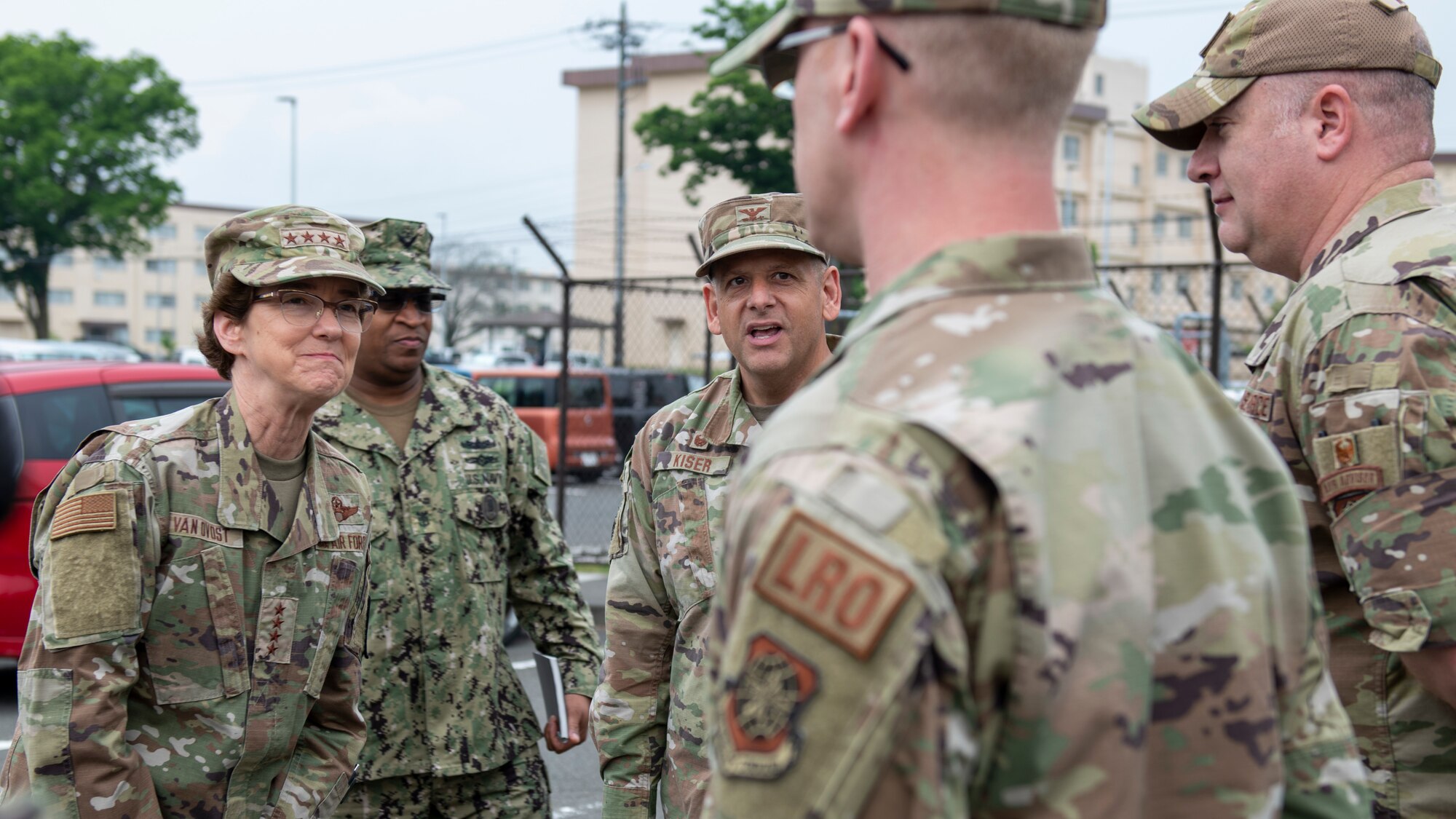 A female general walks in front of a line of Airmen, inspecting them