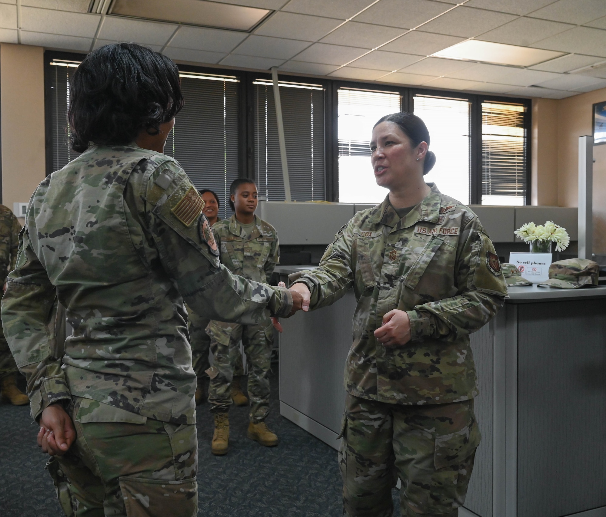 a woman hands a coin to another woman