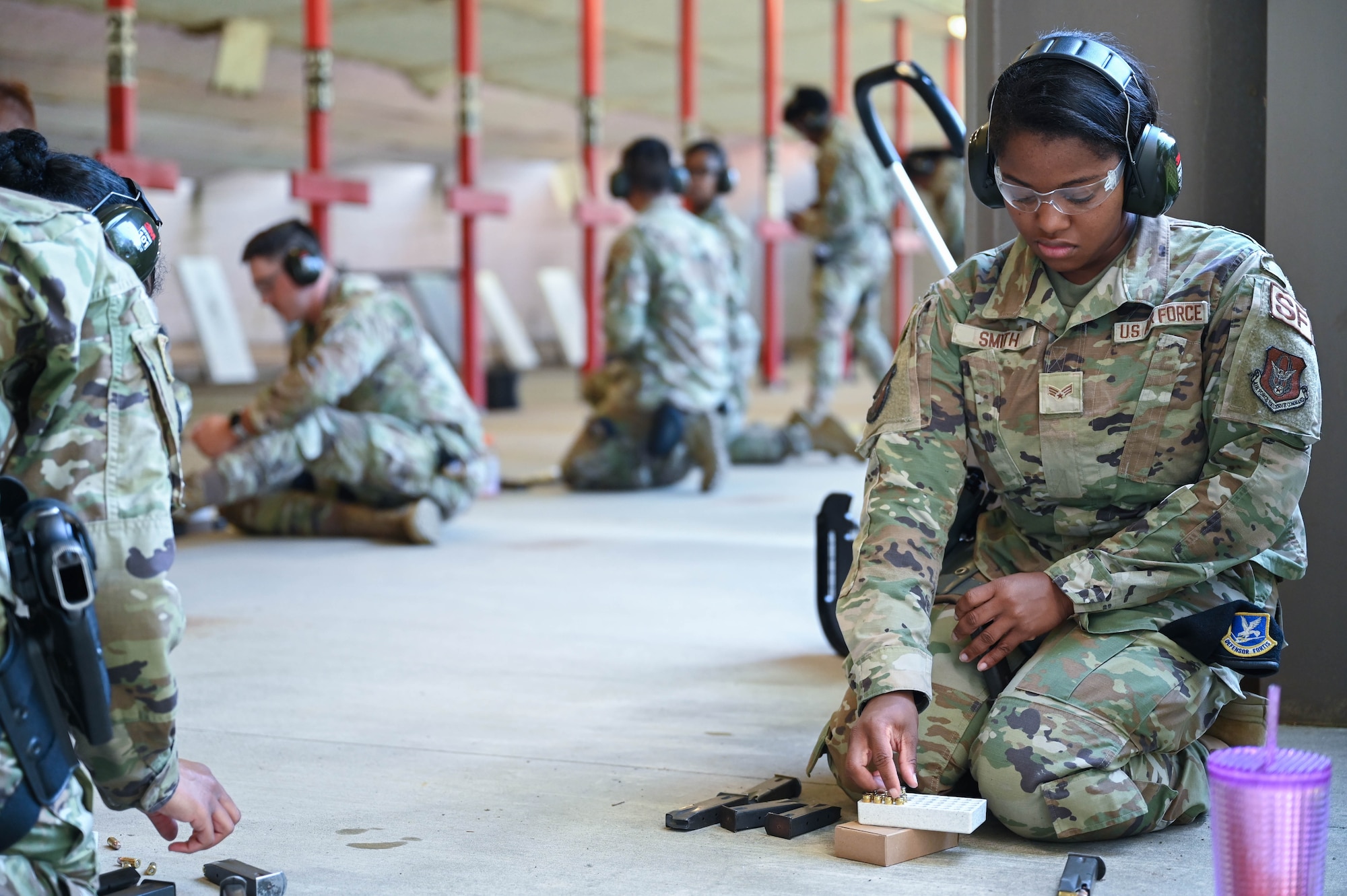 a woman loads rounds into a magazine