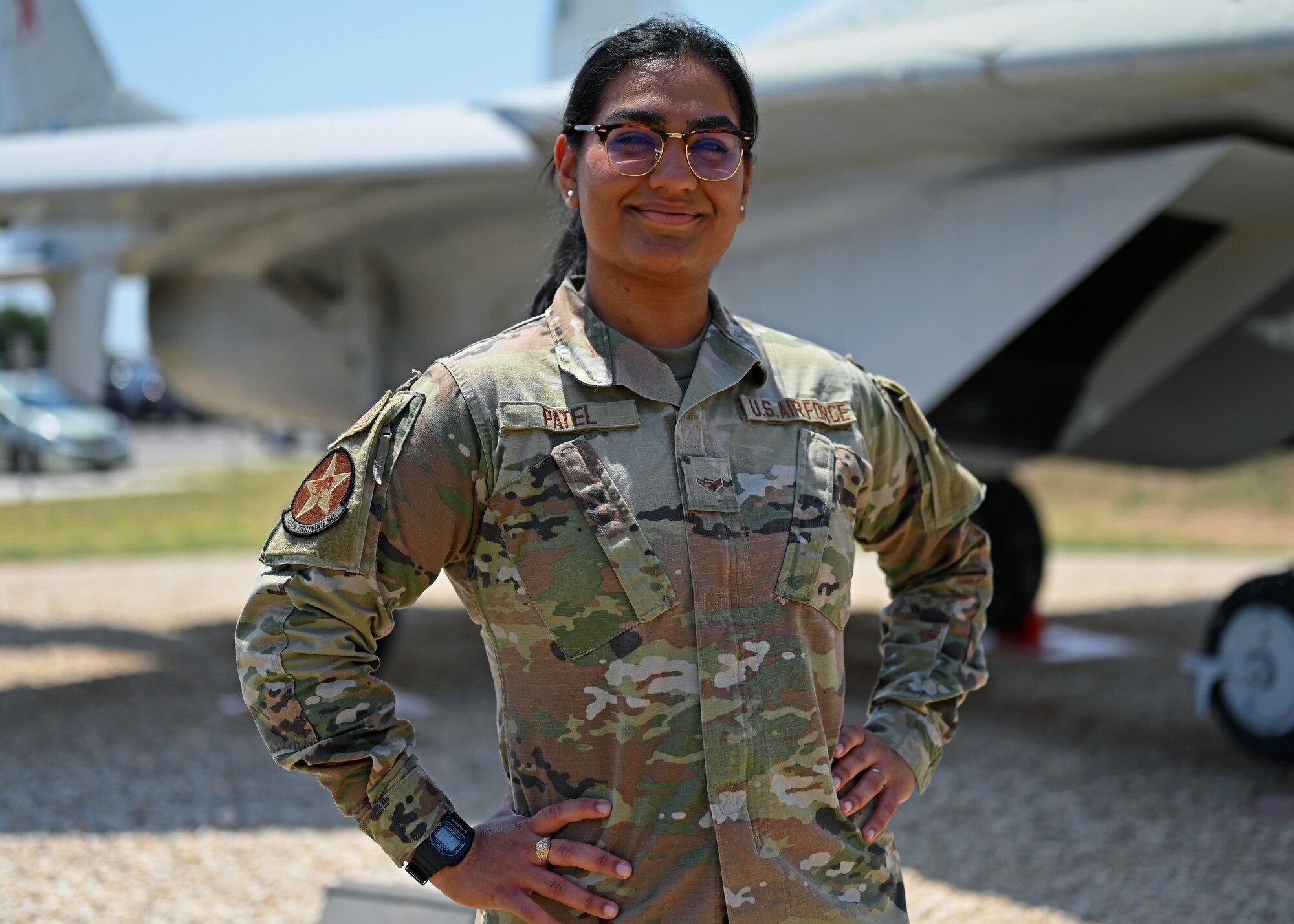 U.S. Air Force Airman 1st Class Shivangi Patel, 316th Training Squadron Russian linguist student, poses in front of a MiG-29 Fulcrum A aircraft configuration trainer at Goodfellow Air Force Base, Texas, May 19, 2022. Patel joined to learn language skills at the world’s premiere language learning facility. (U.S. Air Force photo by Senior Airman Ethan Sherwood)