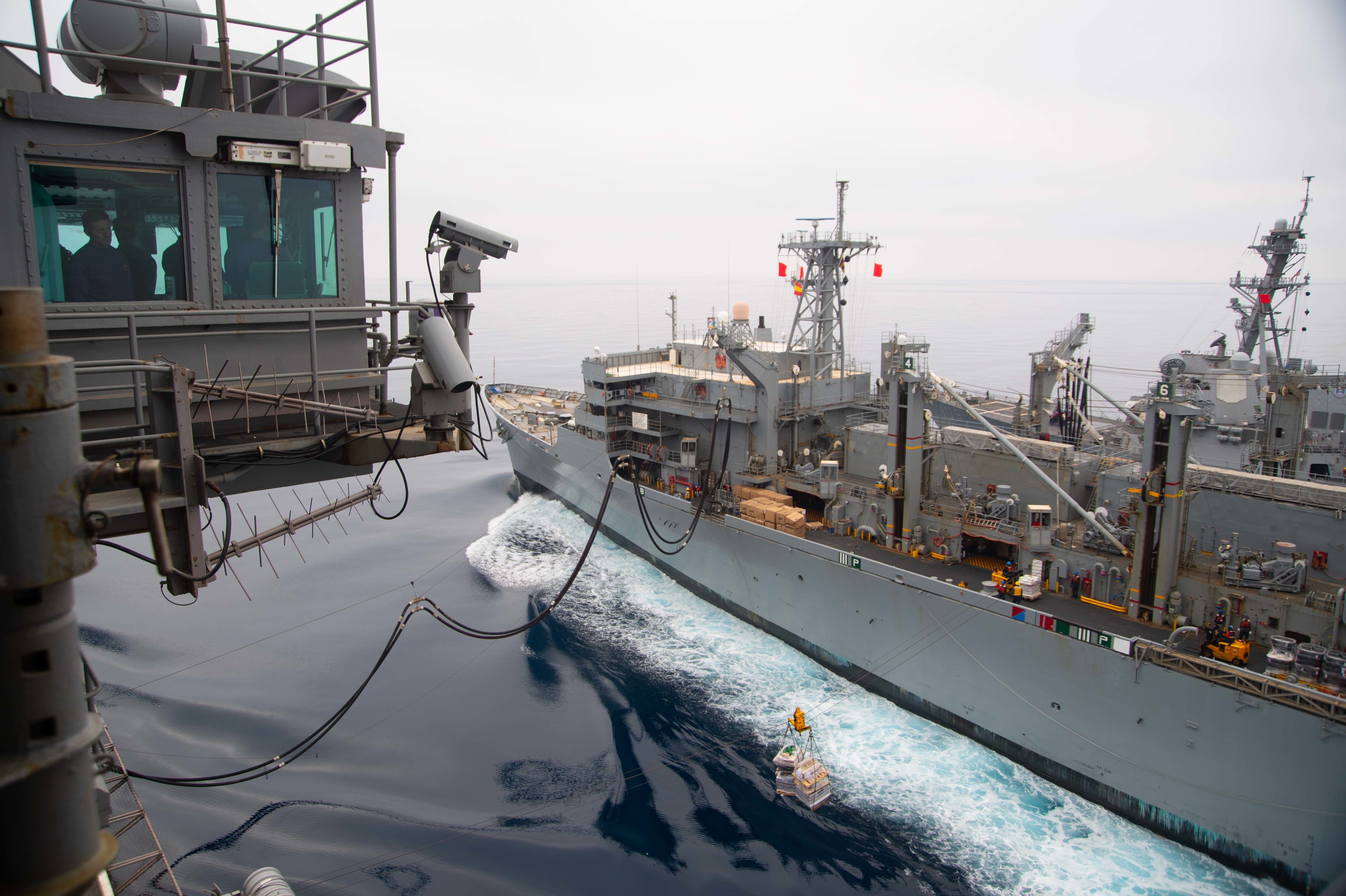 The fast combat support ship USNS Supply (T-AOE 6), right, transits alongside the Nimitz-class aircraft carrier USS Harry S. Truman (CVN 75) during a replenishment-at-sea, May 17, 2022.