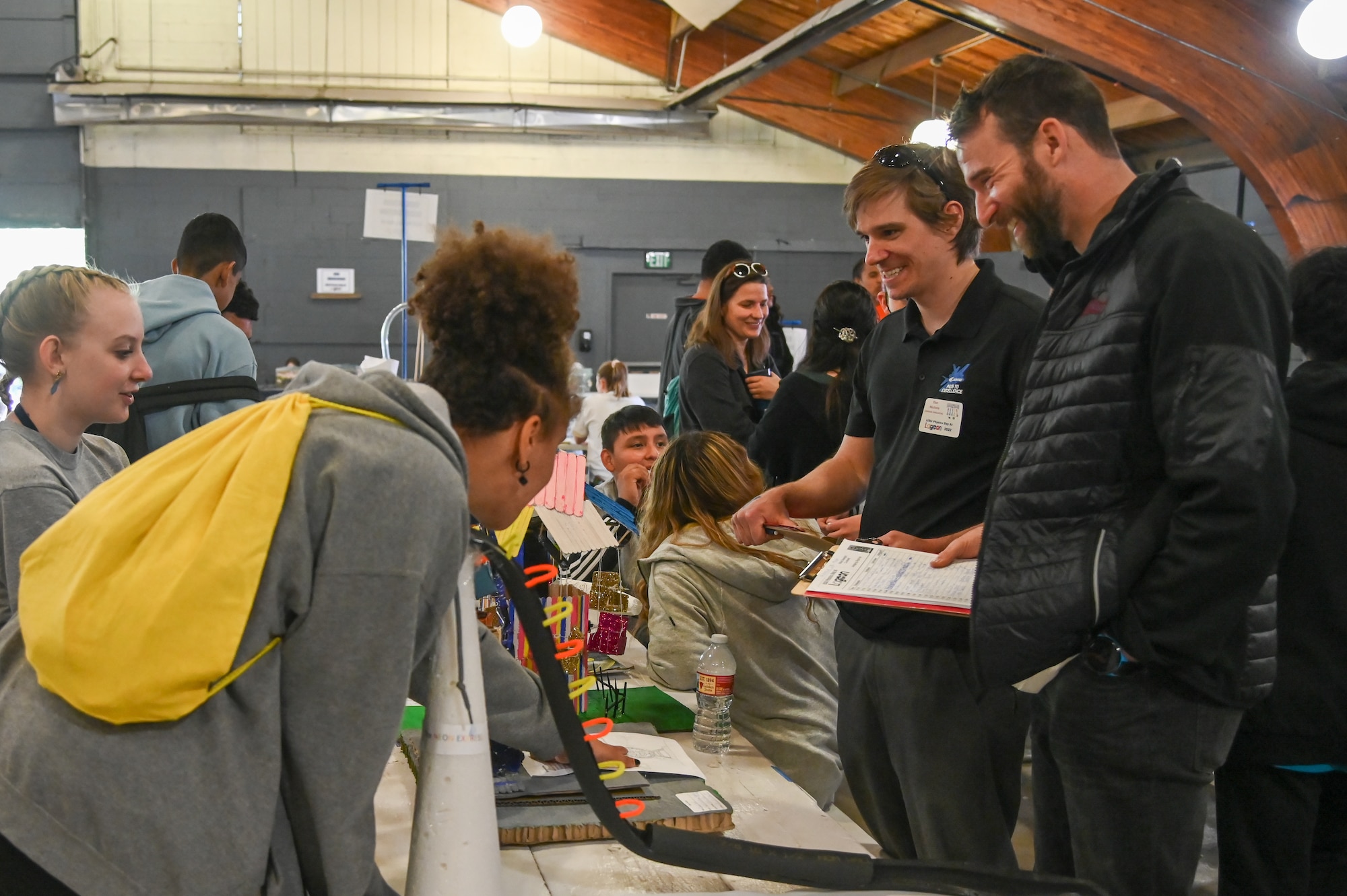 Devin Swanson listens to a students' ride design project presentation during Physics Day May 13, 2022, at Lagoon amusement park in Farmington, Utah.