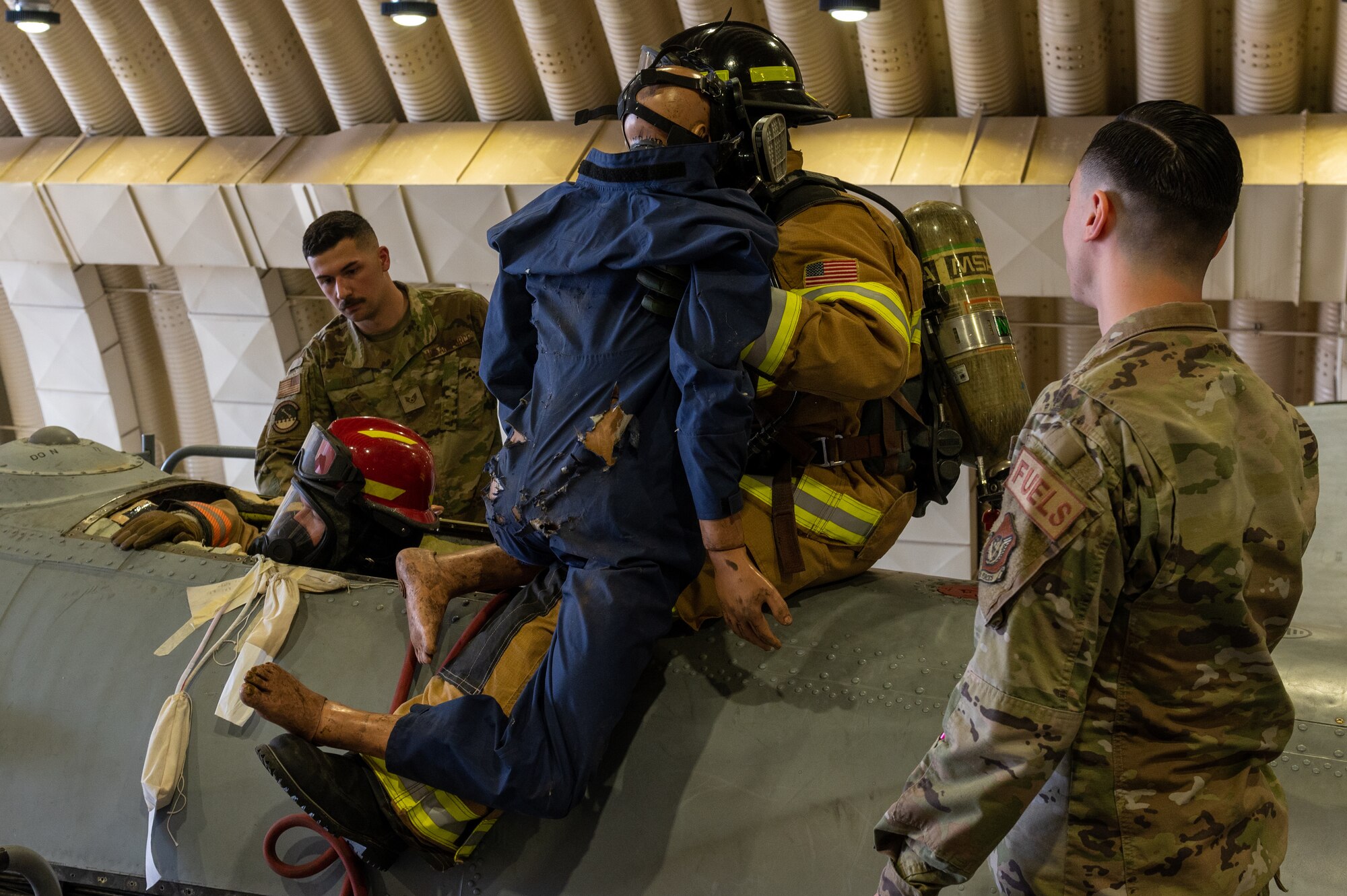 Osan Air Base Fire Department first responders and 51st Maintenance Squadron aircraft fuel systems technicians remove a dummy simulating an unconscious Airman from the fuel tank compartment of an A-10c Thunderbolt during an annual confined space training and safety event
