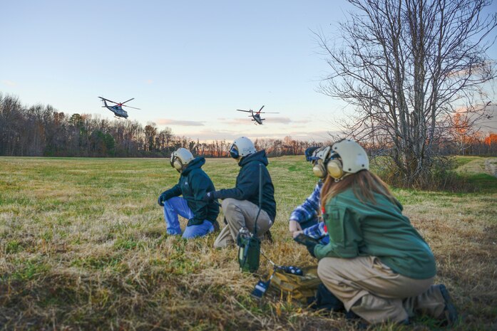 From left, Greg Coulter, DI Lead Engineer with the H-1 Light/Attack Helicopters Program Office, Matt Moritz, Avionics Lead Systems Engineer with the program office, Nick Embry, DI Flight Test Engineer with HX-21, and Victoria Couture, DI Flight Test Engineer with HX-21, successfully test L16 and ANW2 by disembarking from and continuing to communicate with a UH-1Y Venom and an AH-1Z Viper over an encrypted network, marking the first successful digital interoperability flight with an H-1 mixed fleet.