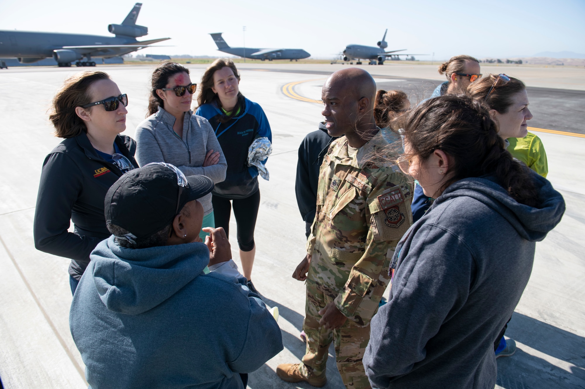 Airmen and civilians converse.