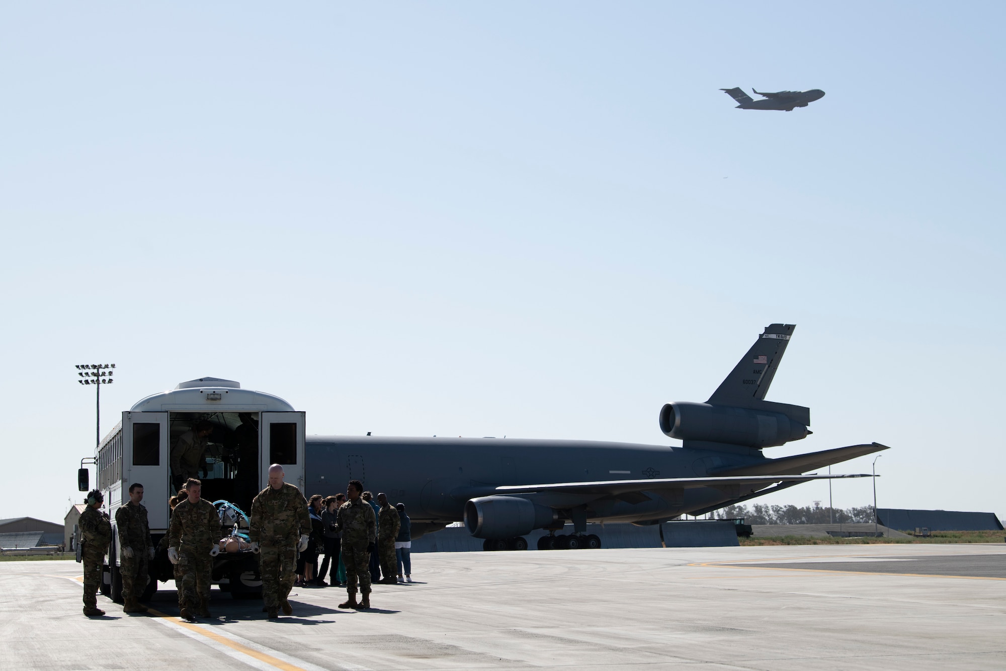 Airmen walk out to a shuttle on the flight-line.