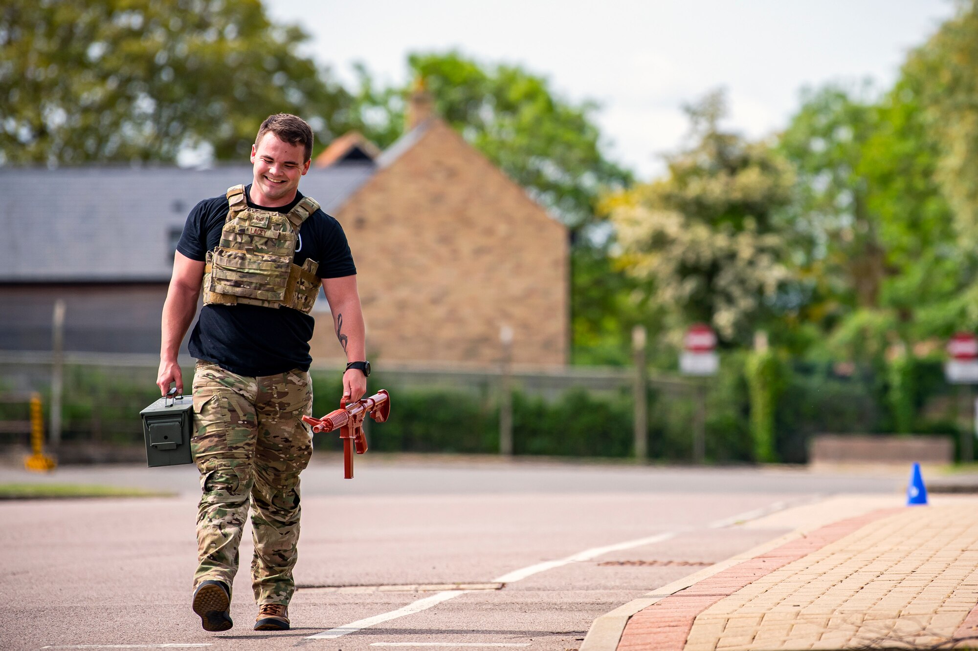 U.S. Air Force Staff Sgt. Josten Lacey, 423d Security Forces Squadron trainer, carries ammo as part of a defender challenge at RAF Alconbury, May 18, 2022. Airmen, civilians and local law enforcement participated in the challenge, held in honor of National Police Week, to pay homage to those who gave their lives in the line of duty. (U.S. Air Force photo by Staff Sgt. Eugene Oliver)