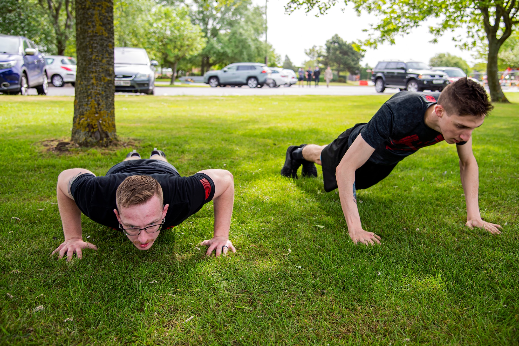 Airmen from the 423d Security Forces Squadron do pushups as part of a defender challenge at RAF Alconbury, May 18, 2022. Airmen, civilians and local law enforcement participated in the challenge, held in honor of National Police Week, to pay homage to those who gave their lives in the line of duty. (U.S. Air Force photo by Staff Sgt. Eugene Oliver)