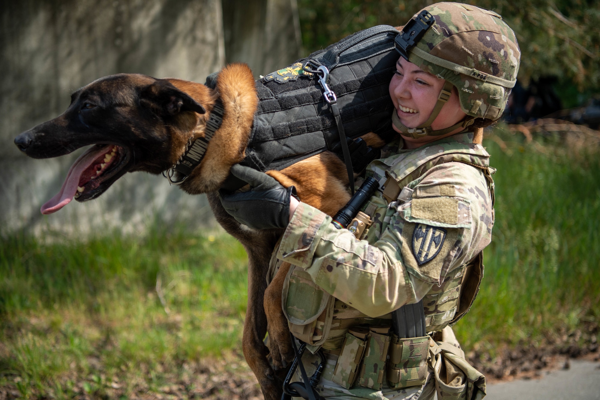 U.S. Army Specialist Elizabeth Netschke,100th Military Police Detachment patrol and narcotics detector K-9 handler, and her K-9 partner, Javier, participate in the 86th Security Forces Squadron 2022 Military Working Dog Competition, at Ramstein Air Base, Germany, May 19, 2022.