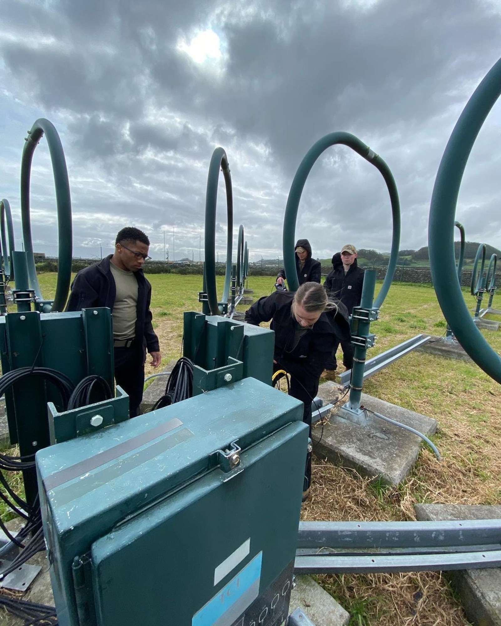 Multiple Airmen working on communications equipment.