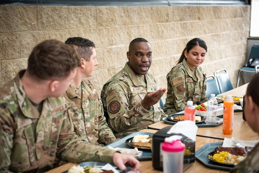 U.S. Air Force Chief Master Sergeant Maurice L. Williams, command chief, Air National Guard, center, joins Airmen of the 193rd Special Operations Wing for lunch during a visit to their unit at the Harrisburg International Airport, Middletown, Pennsylvania, May 15, 2022.