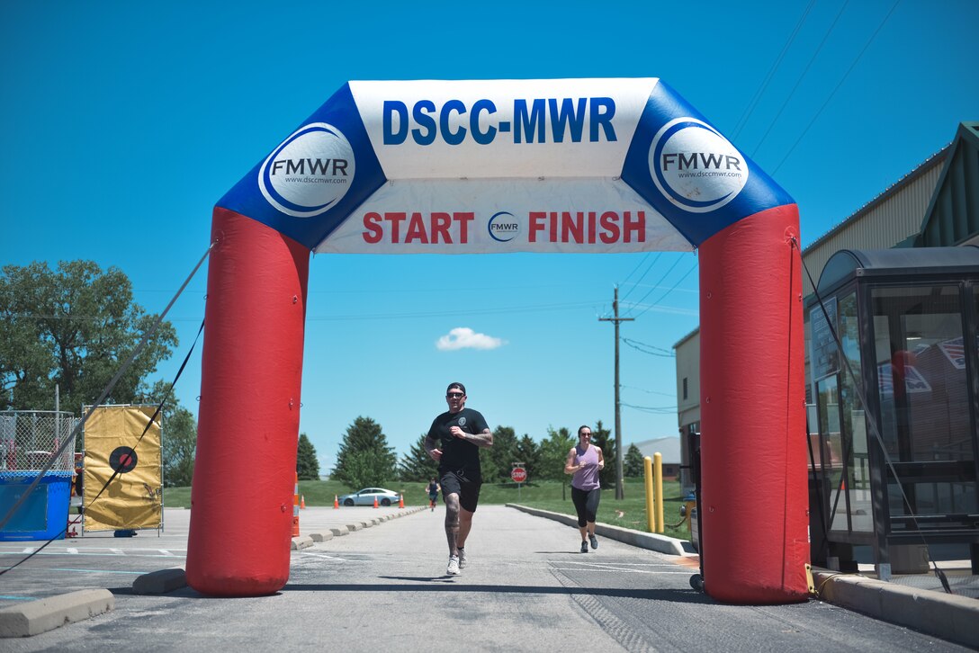Two people running through the blow up gate.