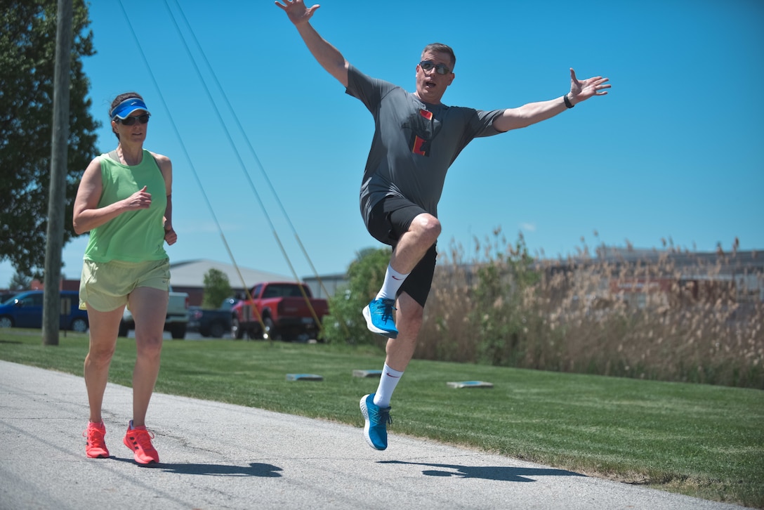 Two people running. One is jumping.