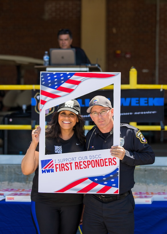 A man and a woman in a photo frame title First Responders outside. The man is in a police uniform.