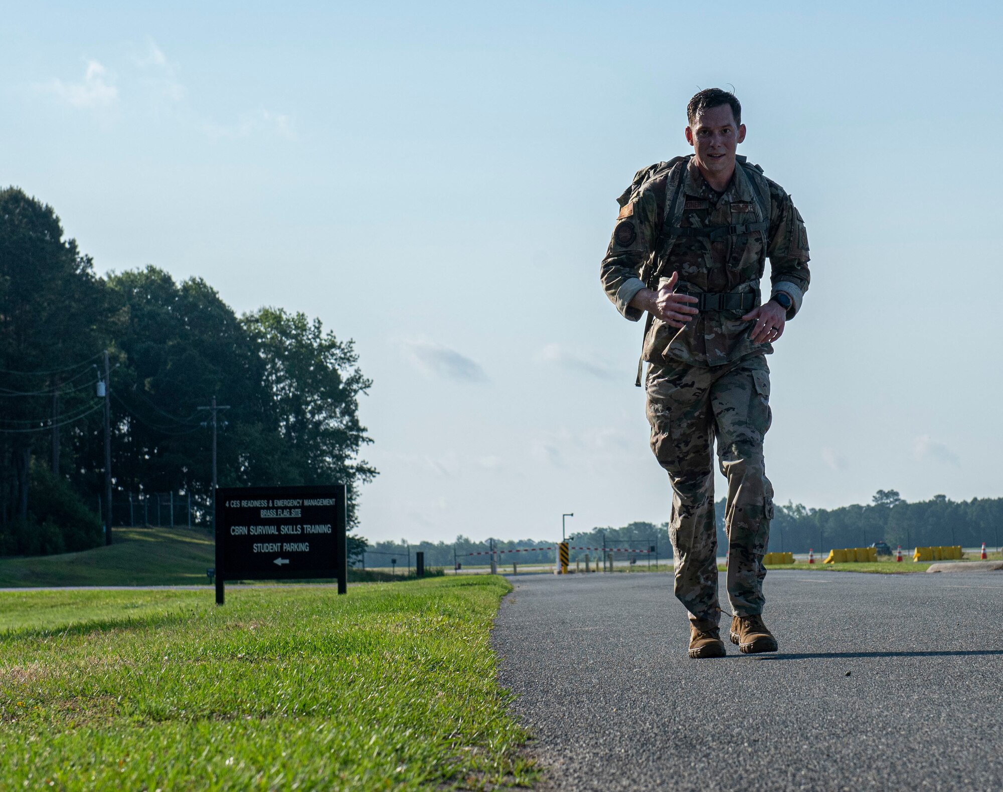 An Airman assigned to the 4th Security Forces Squadron participates in a ruck march in memorial of fallen law enforcement during National Police Week at Seymour Johnson Air Force Base, North Carolina, May 16, 2022. Along the trail of the ruck march, members had posted fallen defenders' pictures with their stories. (U.S. Air Force photo by Airman 1st Class Sabrina Fuller)