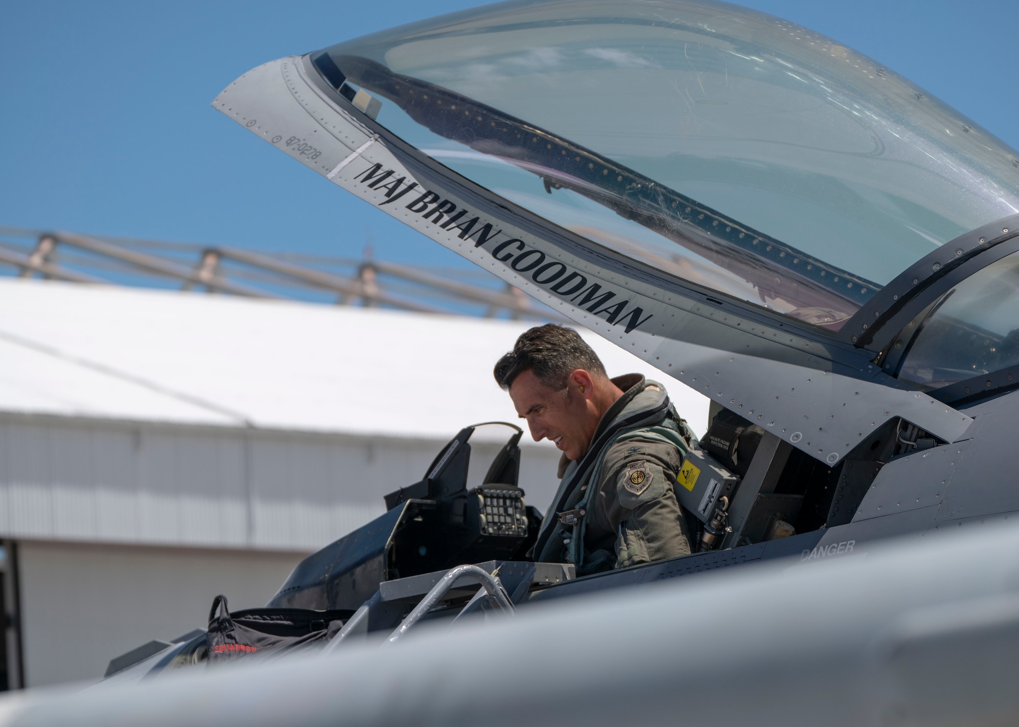 An F-16 Fighting Falcon aircraft pilot prepares his jet for takeoff.