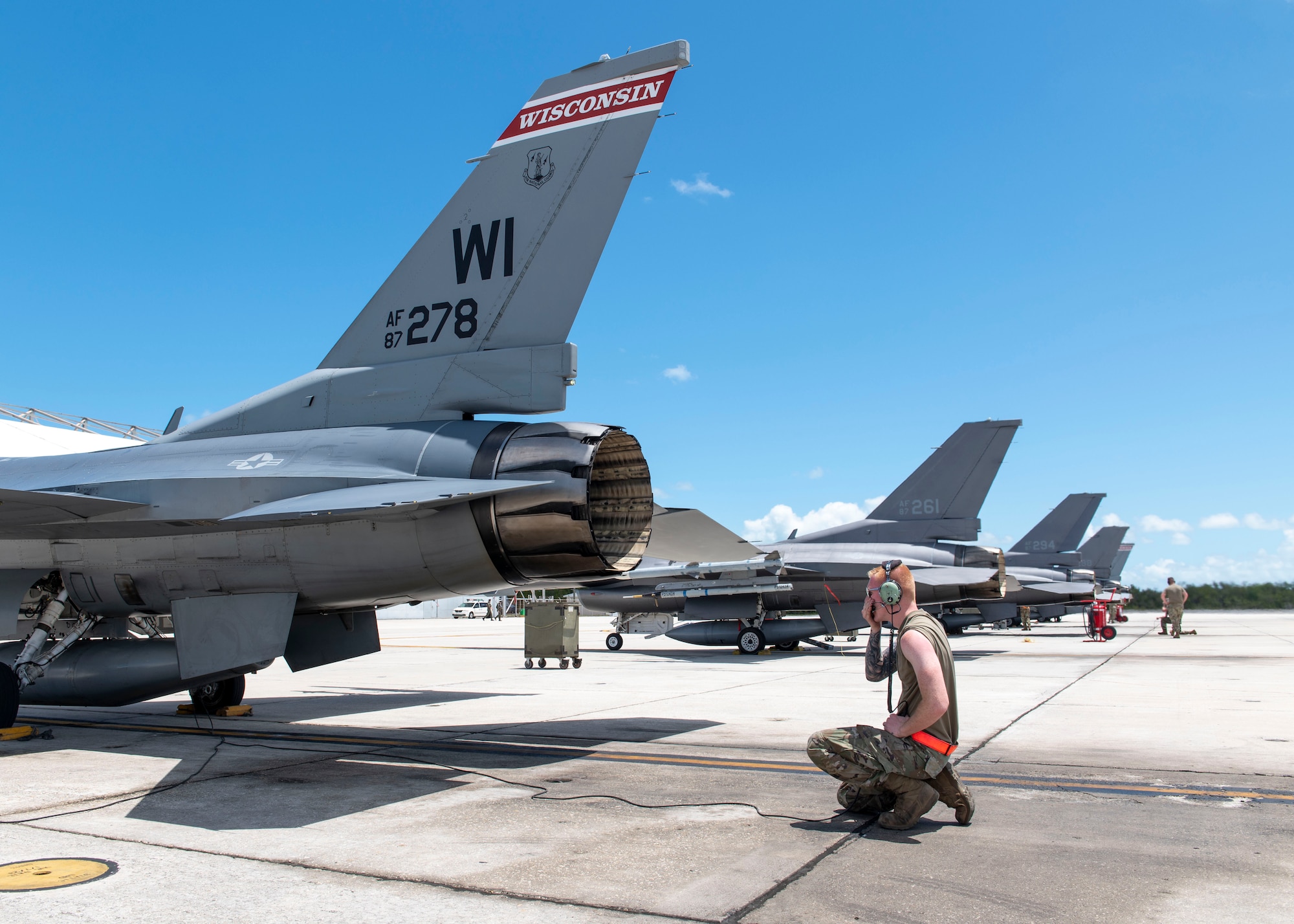 A tactical aircraft maintenance specialist with the U.S. Air Force prepares an F-16 Fighting Falcon aircraft for takeoff.