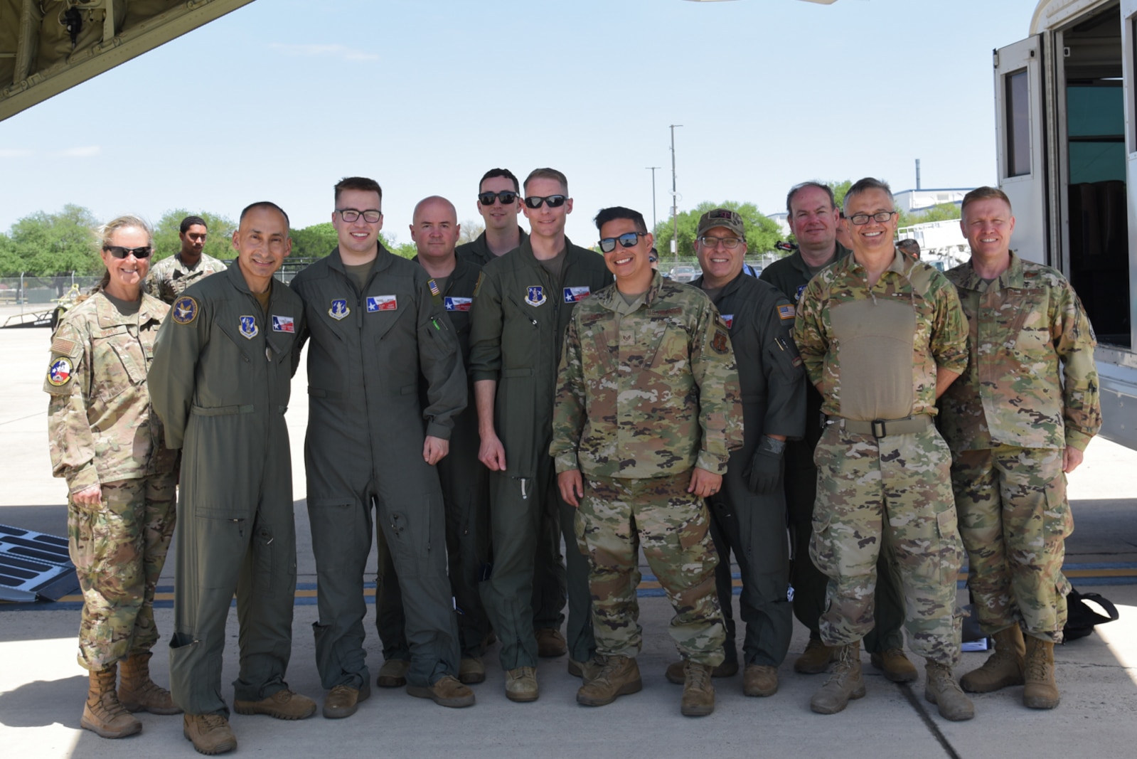 Total Force Airmen pose for photo with C-130J.