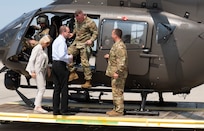 From left: Klaudia Tanner, Austrian minister of defence, Dr. Arnold Kammel, Austrian chief of cabinet and director for defence policy, and Maj. Gen. Greg Knight, Vermont adjutant general, disembark from a Vermont Army National Guard UH-72 Lakota helicopter for a tour of the Army Aviation Support Facility in South Burlington, Vermont, on May 12, 2022. The Vermont National Guard and Austrian Defence Ministry signed a State Partnership Program agreement May 11, 2022, to strengthen interagency cooperation and mutually improve in cyber defense, information operations, military mountaineering, humanitarian and disaster assistance response, and other areas. (U.S. Army National Guard photo by Don Branum)