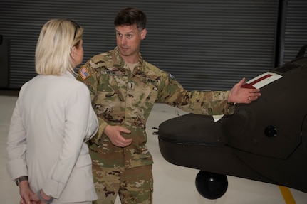 Chief Warrant Officer 4 Phil Vietje, an aviation instructor with C Company, 3-126th Aviation (Air Ambulance), Vermont Army National Guard, shows Austrian Defence Minister Klaudia Tanner around a UH-72 Lakota helicopter at the VTARNG Army Aviation Support Facility in South Burlington, Vermont, on May 12, 2022. The Vermont National Guard and Austrian Defence Ministry signed a State Partnership Program agreement May 11, 2022, to strengthen interagency cooperation and mutually improve in cyber defense, information operations, military mountaineering, humanitarian and disaster assistance response, and other areas. (U.S. Army National Guard photo by Don Branum)