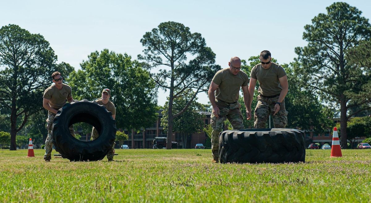 Members assigned to the 4th Security Forces Squadron participate in tire flip competition during National Police Week at Seymour Johnson Air Force Base, North Carolina, May 16, 2022. The competition tested Airmen’s endurance, physical strength and teamwork to highlight defenders lethality and readiness. (U.S. Air Force photo by Airman 1st Class Sabrina Fuller)