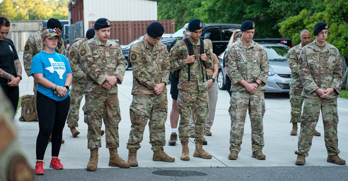 Members assigned to the 4th Security Forces Squadron stand in silence in honor of fallen defenders during National Police Week at Seymour Johnson Air Force Base, North Carolina, May 16, 2022. National Police Week was established in 1962 during President John F. Kennedy’s administration and has been held yearly on May 15. (U.S. Air Force photo by Airman 1st Class Sabrina Fuller)