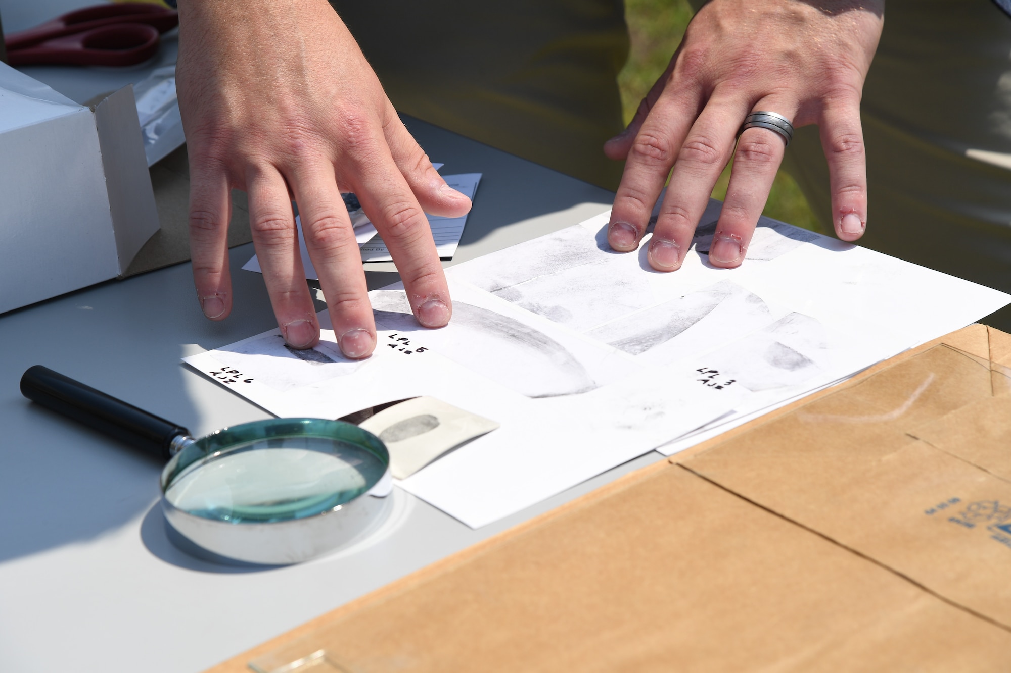 A U.S. Air Force Office of Special Investigations, Detachment 407, special agent displays finger print examples during Police Week defender demo day at Keesler Air Force Base, Mississippi, May 18, 2022. The event was held during National Police Week, recognizing the men and women in law enforcement. (U.S. Air Force photo by Kemberly Groue)