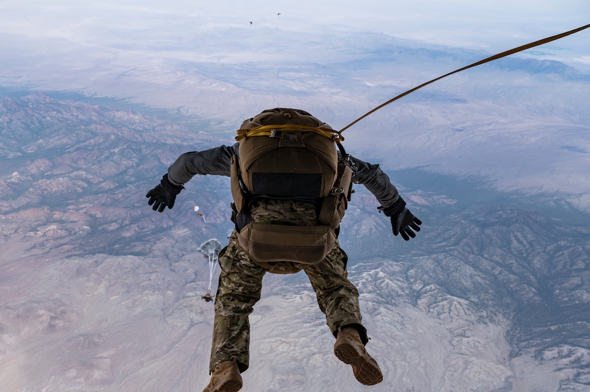 Tech. Sgt. Michael Valeich, 413th Flight Test Squadron Detachment 1 operator, exits the back of a HC-130J Combat King II to conduct a High-Altitude High-Opening (HAHO) jump during a BLACK FLAG 22-1 training mission May 12, 2021, over the Nevada Test and Training Range, Nevada. Black Flag 22-1 is focused on developing and validating large force tactics and integration required to deliver combat capability and tactical advantage for the Combat Air Force to build readiness that credibly deters and successfully defeats adversaries. (U.S. Air Force photo by Tech. Sgt. Alexandre Montes)