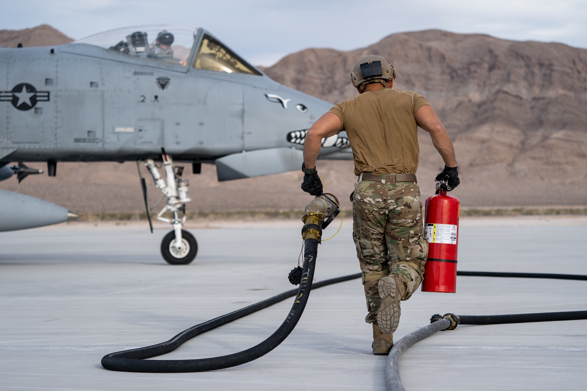 Staff Sgt Fermin Garcia, 355th Logistics Readiness Squadron Forward Area Refueling Point (FARP) operator, Davis-Monthan Air Force Base, Arizona, runs to refuel an A-10 Thunderbolt II during Black Flag 22-1 at Nellis Air Force Base, Nevada, May 12, 2022. The A-10 Thunderbolt II is the first Air Force aircraft specially designed for close air support of ground forces. (U.S. Air Force photo by Airman 1st Class Josey Blades)
