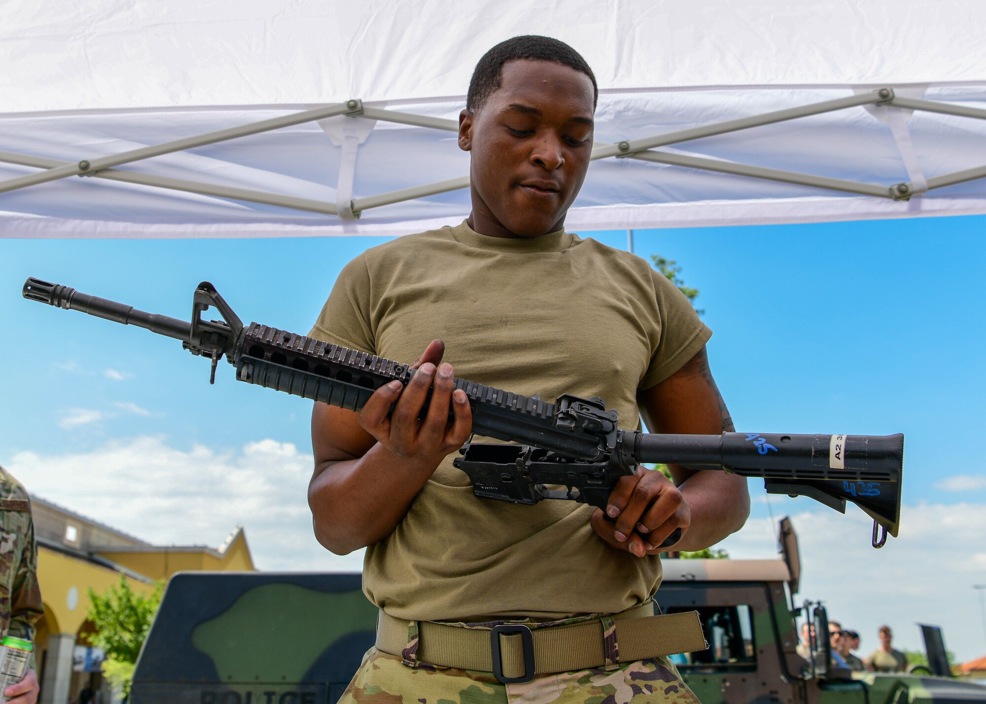 Airman 1st Class Tyson Cribbs, 31st Security Forces Squadron limited exclusion area entry controller, assembles an M4 Carbine during the annual Guns and Hoses competition at Aviano Air Base, Italy, May 18, 2022. The competition consisted of 31st SFS and 31st Civil Engineer Squadron Fire Department competing in events such as a hose drag, litter carry, body drag, tire flips, Keiser FORCE Machine, sprints, M4 carbine assembly and disassembly, and a team Humvee push. Police Week recognizes the service and sacrifice of U.S. law enforcement members, paying special tribute to those who have lost their lives in the line of duty for the safety and protection of others. (U.S. Air Force photo by Senior Airman Brooke Moeder)