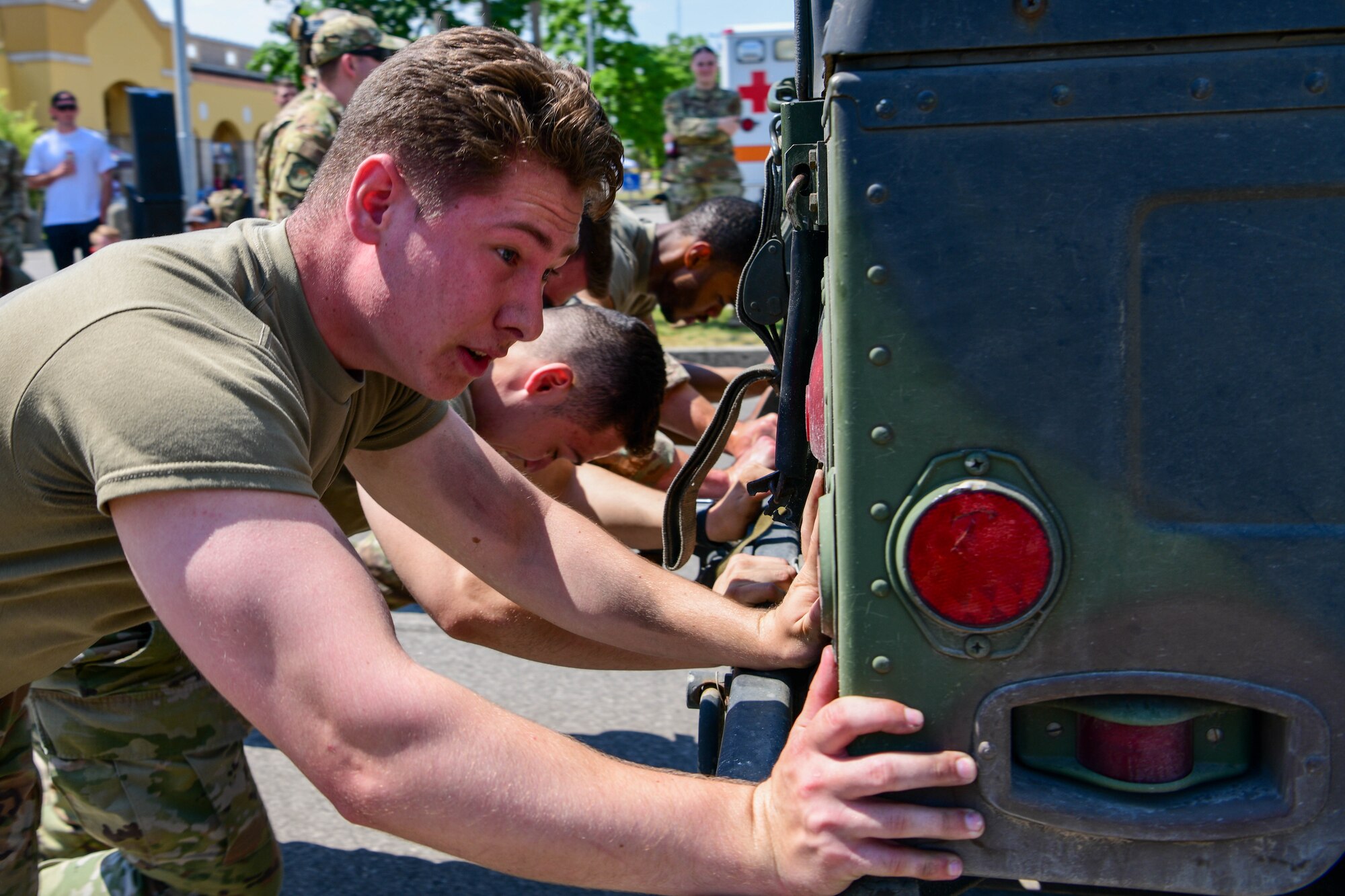 A U.S. Air Force Airman assigned to the 31st Security Forces Squadron pushes a Humvee with his team during a Guns and Hoses competition at Aviano Air Base, Italy, May 18, 2022. The 31st SFS competed against the 31st Civil Engineer Squadron Fire Department in an obstacle course themed after challenges from their respective jobs. In 1962, President Kennedy declared Peace Officers Memorial Day to be observed on May 15 and recognized May 15 as National Police Week. (U.S Air Force photo by Senior Airman Brooke Moeder)