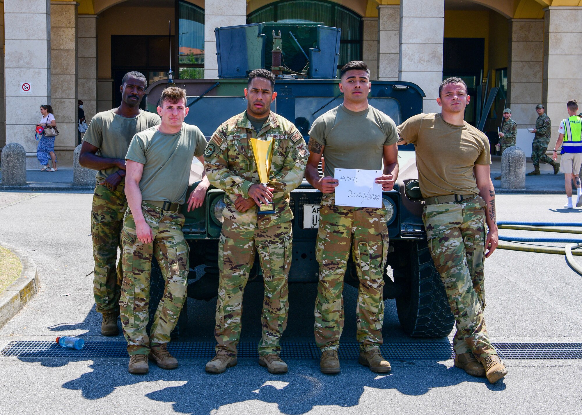 U.S. Air Force Airmen assigned to the 31st Civil Engineer Squadron Fire Department pose for a photo after winning the annual Guns and Hoses competition at Aviano Air Base, Italy, May 18, 2022. Airmen from the 31st Security Forces Squadron and 31st CES competed in an obstacle course themed after challenges from their respective jobs in honor of Police Week. Police Week recognizes the service and sacrifice of U.S. law enforcement members, paying special tribute to those who have lost their lives in the line of duty for the safety and protection of others. (U.S. Air Force photo by Senior Airman Brooke Moeder)
