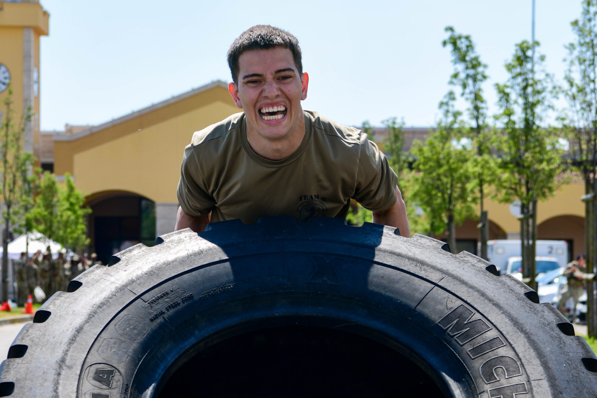 Airman 1st Class Joshua Trevino, 31st Security Forces Squadron limited exclusion area entry controller, lifts a tire in the annual Guns and Hoses competition during Police Week at Aviano Air Base, Italy, May 18, 2022. The 31st SFS competed against the 31st Civil Engineer Squadron Fire Department in an obstacle course themed after challenges from their respective jobs. Police Week recognizes the service and sacrifice of U.S. law enforcement members, paying special tribute to those who have lost their lives in the line of duty for the safety and protection of others. (U.S. Air Force photo by Senior Airman Brooke Moeder)