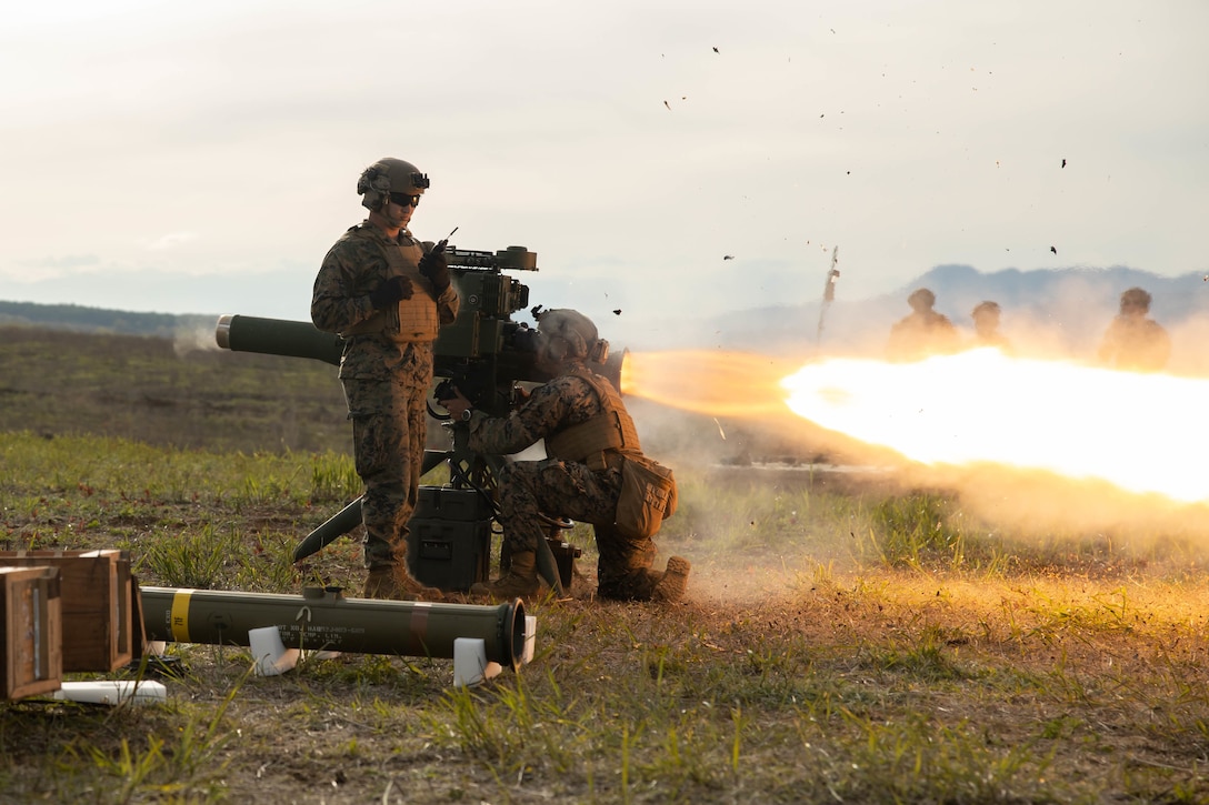 Two Marines fire a missile during a training exercise.