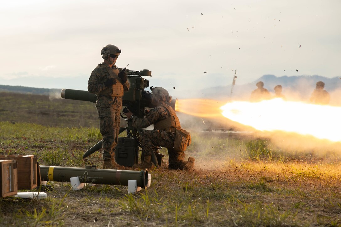 Two Marines fire a missile during a training exercise.