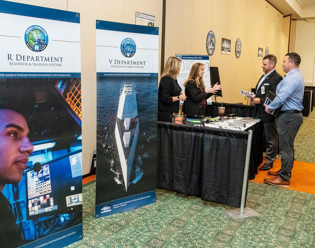 IMAGE: Naval Surface Warfare Center Dahlgren Division (NSWCDD) Chief Technology Officer Jennifer Clift (second from left) talks with attendees at the 2022 NSWCDD Outreach and Industry Day, May 18. The event provided an opportunity to share a wide array of opportunities to area small and large business industry partners who are hoping to team with NSWCDD on future endeavors.