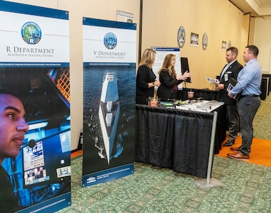 IMAGE: Naval Surface Warfare Center Dahlgren Division (NSWCDD) Chief Technology Officer Jennifer Clift (second from left) talks with attendees at the 2022 NSWCDD Outreach and Industry Day, May 18. The event provided an opportunity to share a wide array of opportunities to area small and large business industry partners who are hoping to team with NSWCDD on future endeavors.