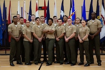 U.S. Marines with Fleet Marine Force, Atlantic (FMFLANT), Marine Forces Command (MARFORCOM), Marine Forces Northern Command (MARFOR NORTHCOM), Headquarters Marine Corps Intelligence School Training Command and Expeditionary Warfare Training Group, Atlantic gather around their Lance Cpl. Leadership and Ethics Seminar 1-22 instructors from FMFLANT, MARFORCOM, MARFOR NORTHCOM at Hopkins Hall Gymnasium, Virginia, May 20, 2022. These Marines graduated from a week-long course consisting of knowledge assessment, physical training and open leadership discussions. The Lance Cpl. Leadership and Ethics Seminar is designed to reaffirm the values, ethos, and principles of small unit leadership and is required training for Marines prior to achieving the non-commissioned officer rank of Corporal. (U.S. Marine Corps photo by Lance Cpl. Angel Alvarado)