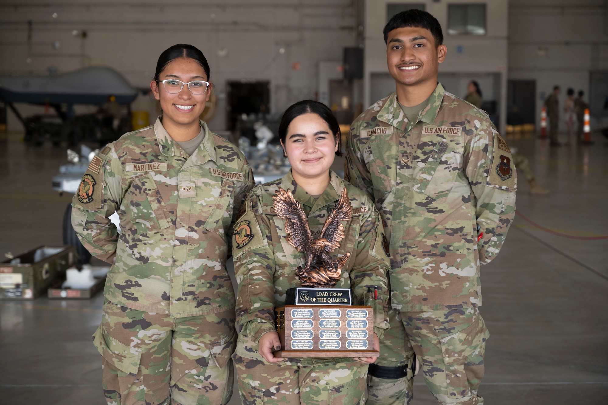 From left to right,
Airman 1st Class
Yajahira Martinez, 9th
Aircraft Maintenance
Unit weapons load crew
member; Senior Airman
Hannah Canfield, 9th
AMU weapons load
crew team chief; and
Airman 1st Class Kevin
Camacho, weapons load
crew member, hold the
first place trophy for
the 2022 first quarter
load competition, May
16, 2022, on Holloman
Air Force Base, New
Mexico.