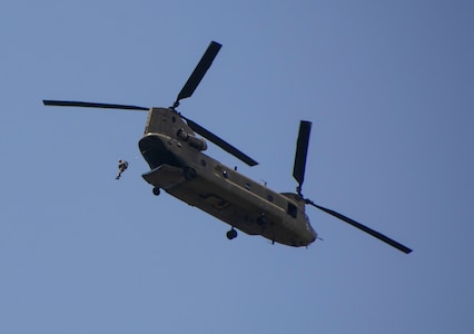 An Airman from the 14th Air Support Operations Squadron jumps from a Pennsylvania Army National Guard CH-47 Chinook during airborne operations at Fort Indiantown Gap, Pa. The pilots and crew chiefs of the Chinook worked to provide the Airmen with a stable platform as they moved over the drop area.