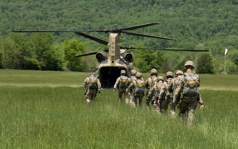 Service members board a Pennsylvania Army National Guard CH-47 Chinook during airborne training May 18, 2022, at Fort Indiantown Gap, Pa. The service members were conducting their second jump of the day.