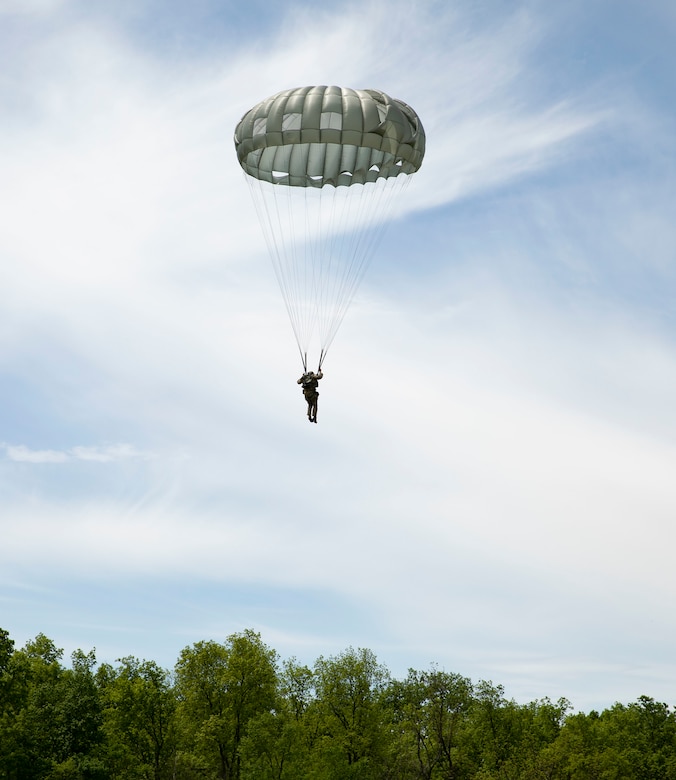 An Airman parachutes toward the ground after jumping from a Pennsylvania Army National Guard CH-47 Chinook during airborne operations May 18, 2022, at Fort Indiantown Gap, Pa. Service members from the 14th Air Support Operations Squadron and 148th ASOS took part in the joint training.